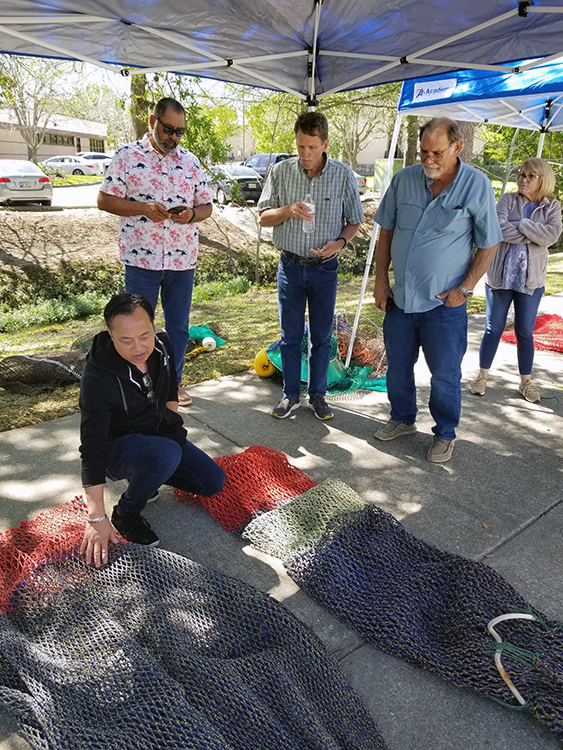 Shrimp fishers looking at nets. 